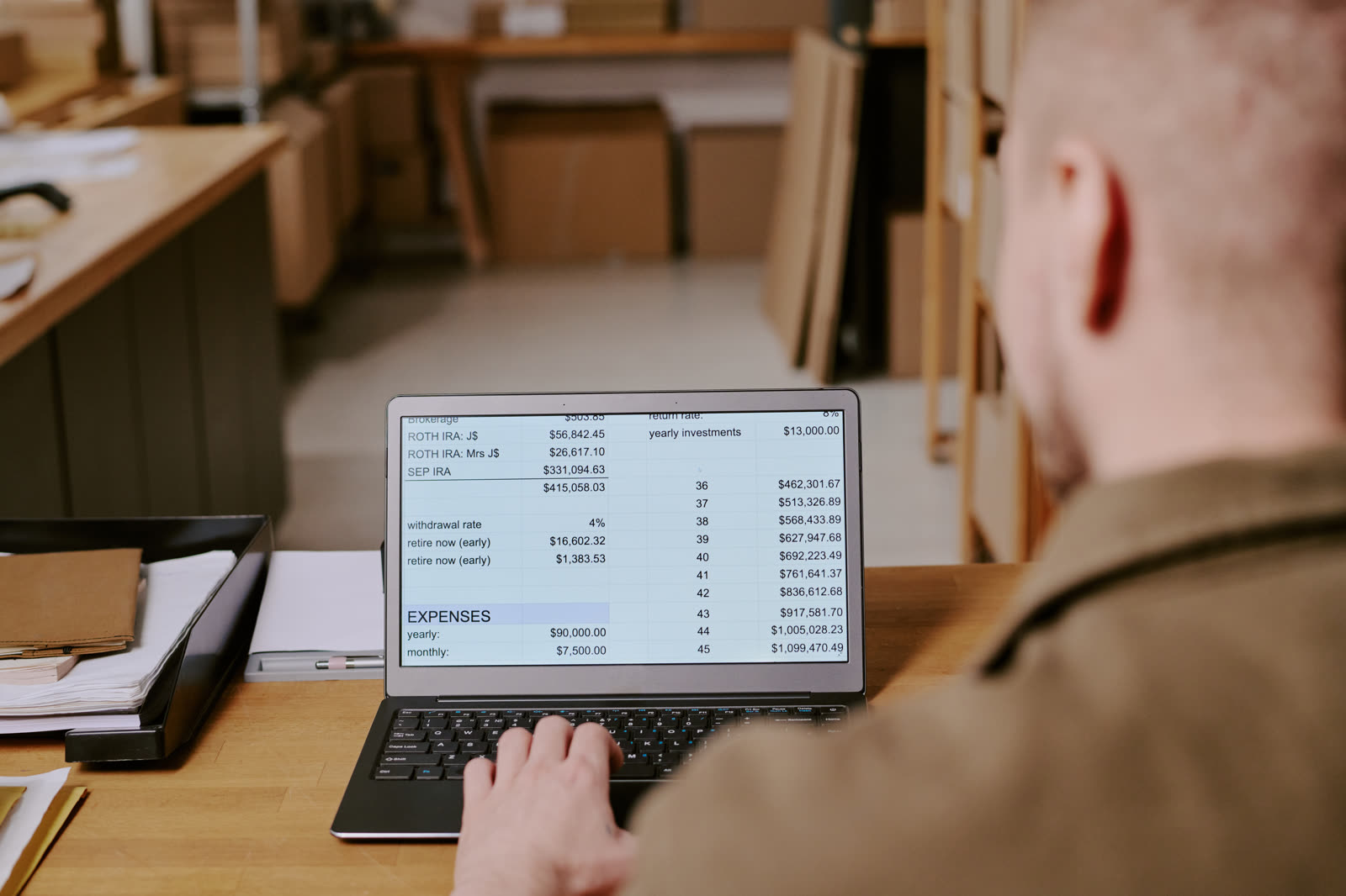 A small business owner in Oklahoma checking ad performance on a laptop at their front counter