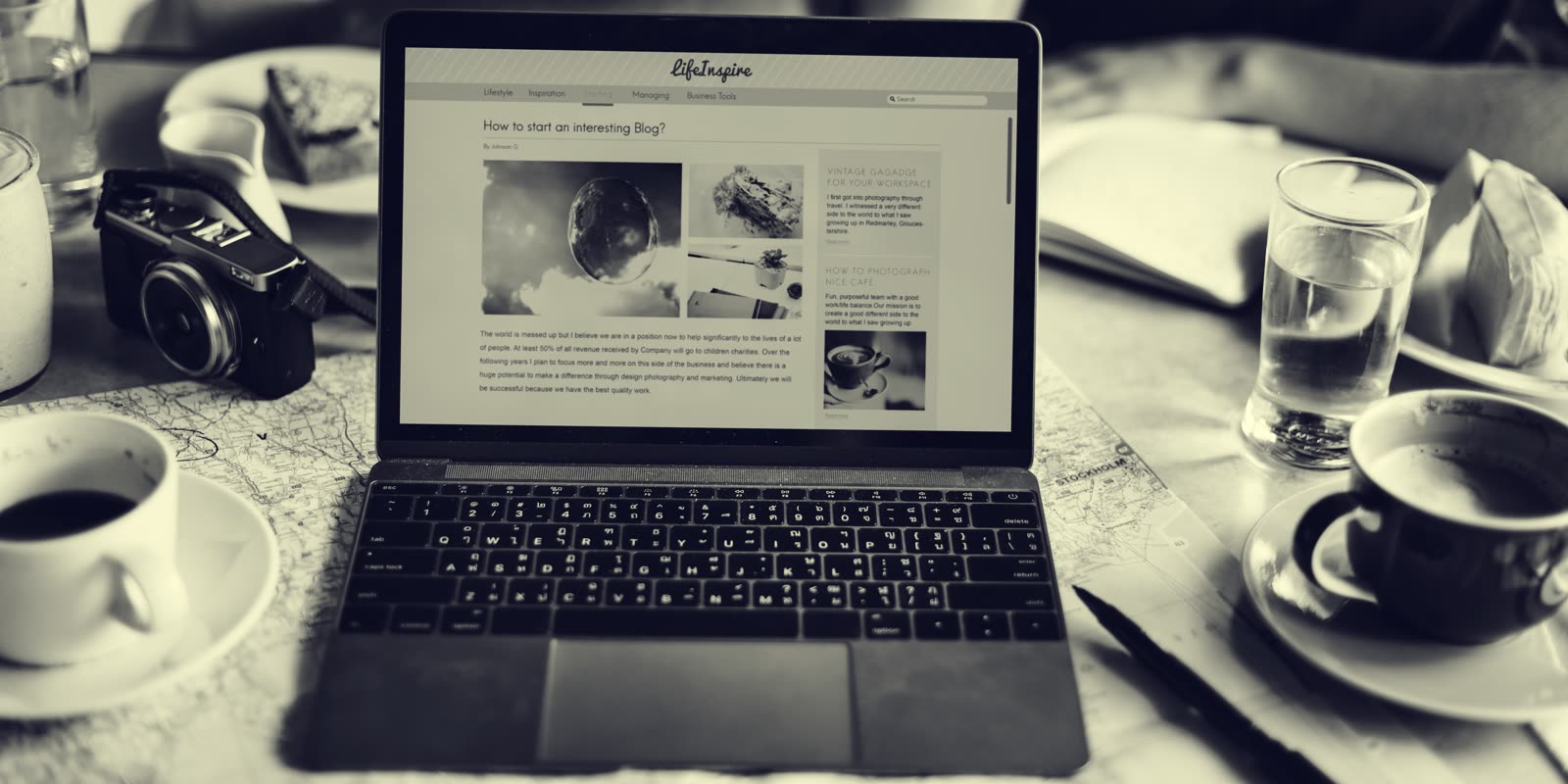 Small business owner reviewing their website on a laptop at the counter of their shop