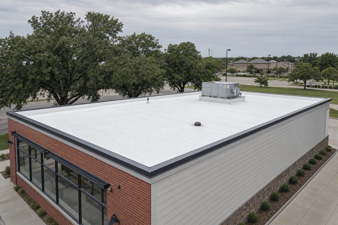 A low-slope commercial TPO membrane roof on a small retail building