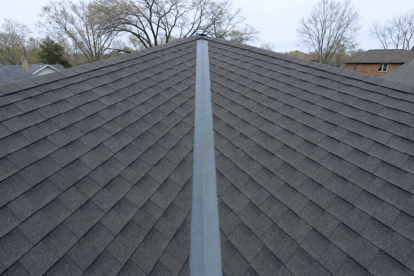 A finished roof valley with new metal valley flashing where two planes meet